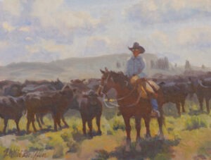 A cowboy in sunglasses working a roundup