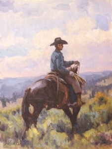 A cowboy searching through sagebrush for strays