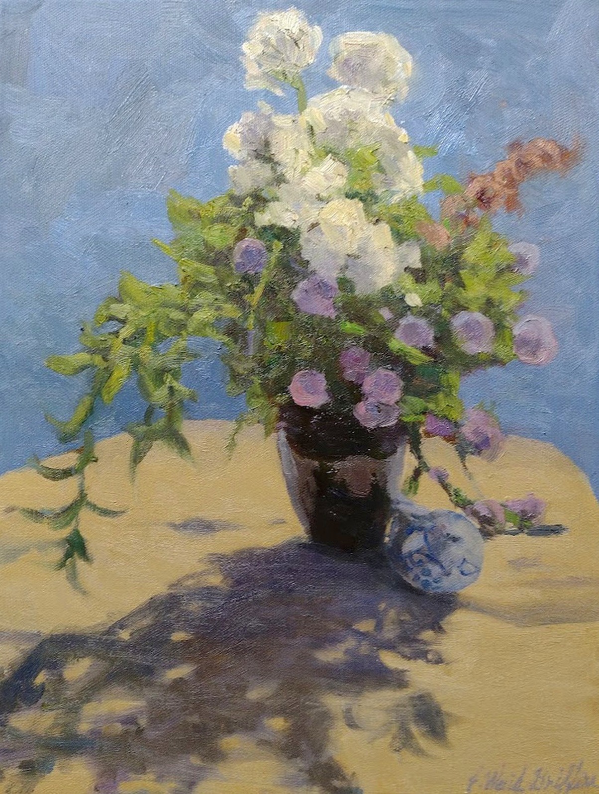 Herb blossoms a vase and a ceramic bird on a table