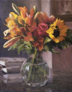 Lilies, roses, and sunflowers in a crystal vase